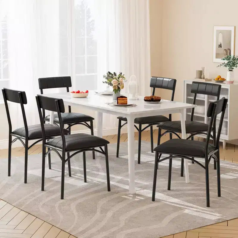 Four dining chair sets, with soft cushions and ergonomic high backs. Strong steel legs, suitable for dining rooms and kitchens. Black color.