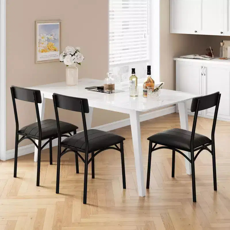 Four dining chair sets, with soft cushions and ergonomic high backs. Strong steel legs, suitable for dining rooms and kitchens. Black color.