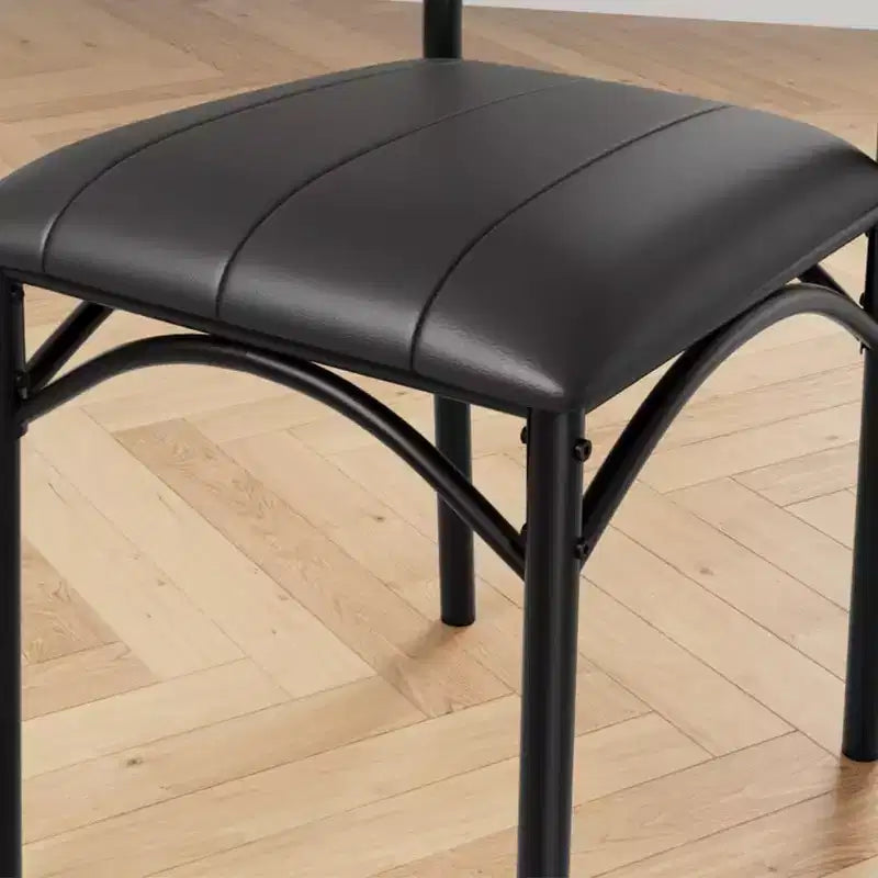 Four dining chair sets, with soft cushions and ergonomic high backs. Strong steel legs, suitable for dining rooms and kitchens. Black color.